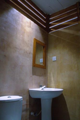 a bathroom with a sink and a toilet at Arugambay Wave House in Arugam Bay