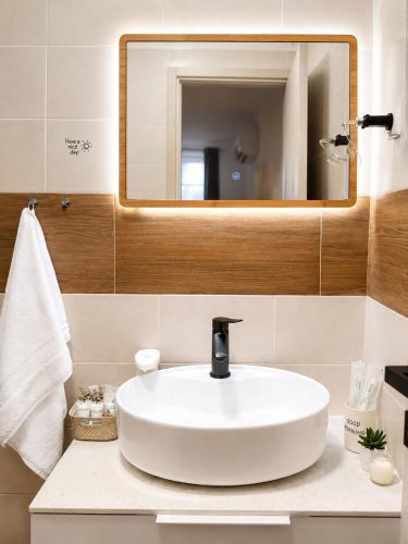 a bathroom with a white sink and a mirror at Room Jakov in Šibenik