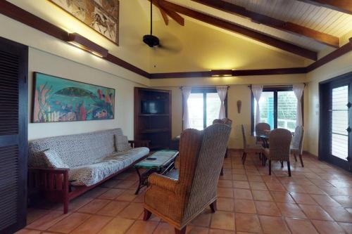 a living room with a couch and a table and chairs at Condo #31 @ Beachside Villas in Placencia
