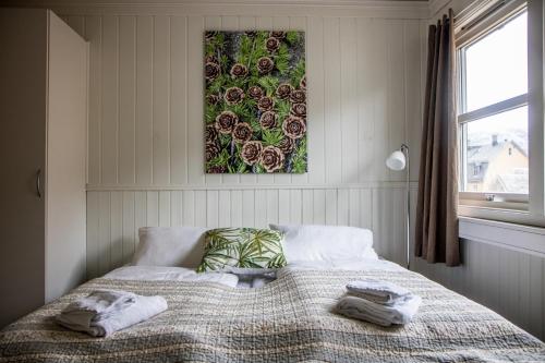 a bedroom with a bed with a picture on the wall at Valldal Fjord Lodge B&B in Valldal