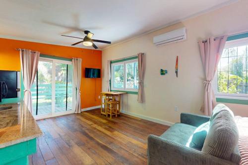 a living room with a couch and a tv at Casita in Placencia