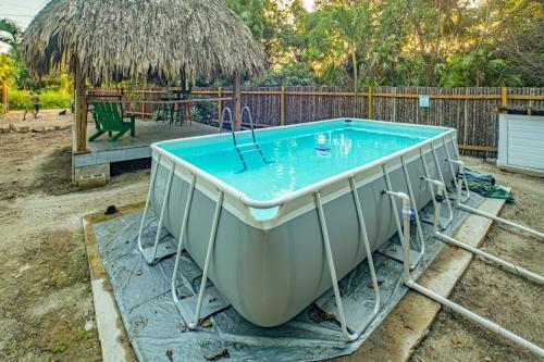 a bath tub sitting in a yard with a table at 2 Coco Locos at Sunset in Seine Bight Village