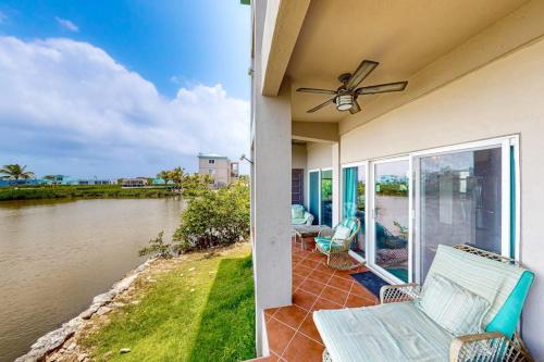 a house with a balcony with a view of a river at Suite H103 @ Mara Laguna in San Pedro