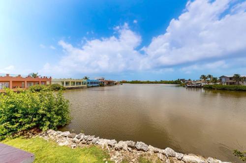 a view of a river with houses and buildings at Suite H103 @ Mara Laguna in San Pedro