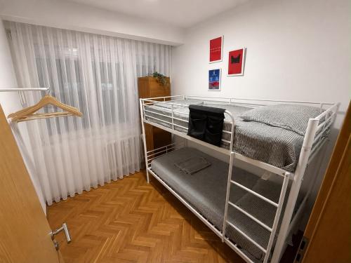 a room with a bunk bed in a room at The Art Ceiling Loft at Main Square in Prishtinë