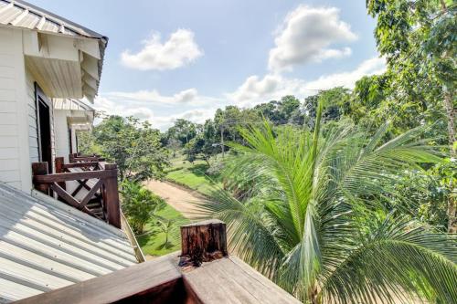 a balcony of a house with a view of a forest at Crow's Nest Suite at Mahogany Hall -Gold Standard Certified in San Ignacio