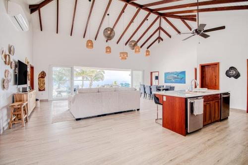 a large living room with a couch and a table at Tres Palmas Beach House in Maya Beach