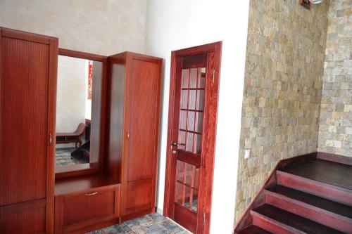 a room with a door and a mirror and stairs at Brech Resort&Spa in Gurinovka Staraya