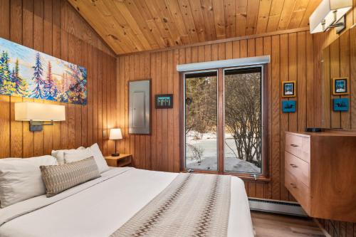 a bedroom with a large bed and a window at Lutsen Sea Villas in Lutsen