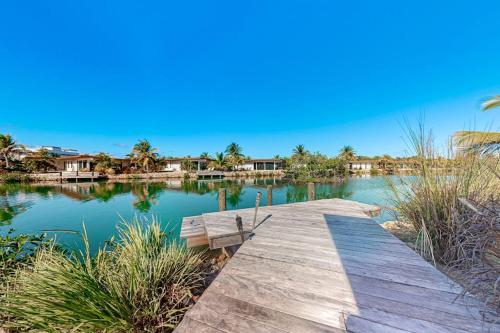a wooden dock in the middle of a lake at Seabird - Villa 26 in Placencia