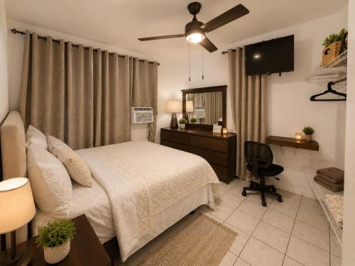 a bedroom with a bed and a desk and a chair at Natural Village ROOM #1,2,3 & 5 in San Juan