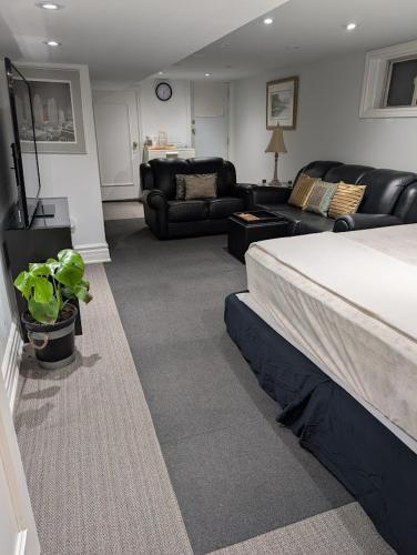 a bedroom with a bed and a living room at King Size In-Suite Basement in Toronto