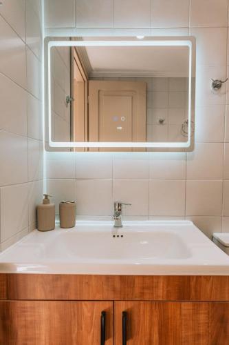 a bathroom with a sink and a mirror at Casa Autentica 1933 in Kos
