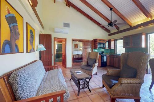 a living room with a couch and chairs and a table at Condo #22 @ Beachside Villas in Seine Bight Village