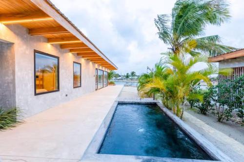 a swimming pool in the middle of a house at Seabird Villa 11 in Placencia