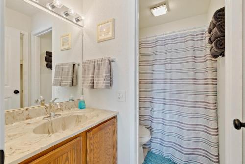 a bathroom with a sink and a shower at Baypoint Paradise in Osage Beach
