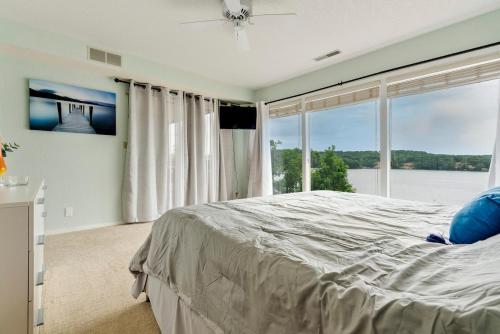 a bedroom with a large bed and a large window at Baypoint Paradise in Osage Beach