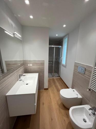 a bathroom with two sinks and a toilet at mama house in Marotta