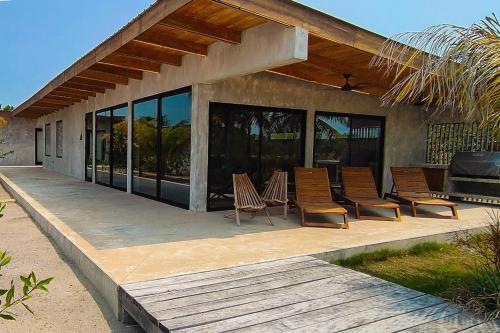 a group of chairs sitting on a patio at Seabird - Villa 1 in Placencia