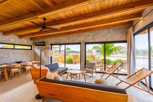 a living room with a couch and a table at Seabird - Villa 10 in Placencia