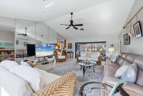 a living room with white furniture and a ceiling fan at 830 Coronado in Punta Gorda