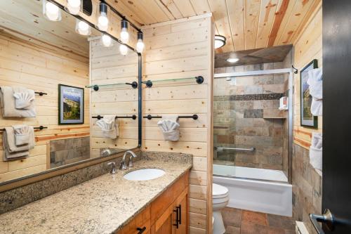 a bathroom with a sink and a toilet and a tub at Lutsen Sea Villas in Lutsen
