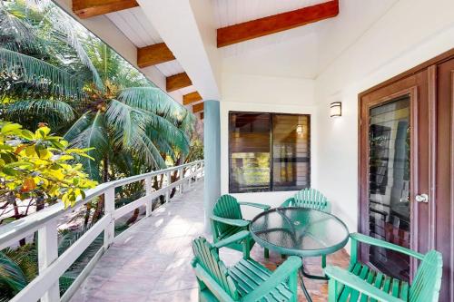 a balcony with a glass table and chairs at Condo #27 @ Beachside Villas in Seine Bight Village