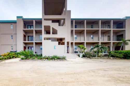 a building on the beach in front of a building at Suite E303 Mara Laguna in San Pedro