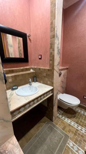 a bathroom with a sink and a toilet at Les Jardins de la Palmeraie 3 in Marrakesh