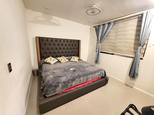 a bedroom with a large bed in a room at Home La Reina in Guadalajara