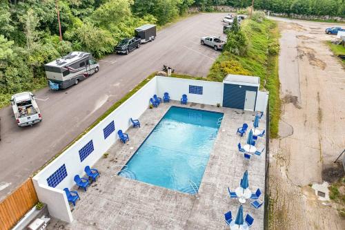an aerial view of a pool with chairs and a truck at Gilford Beachfront Stay, Pool, WiFi & Parking Incl in Laconia