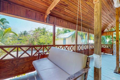 a porch with a hammock and a swing at Casa Jessita in Caye Caulker
