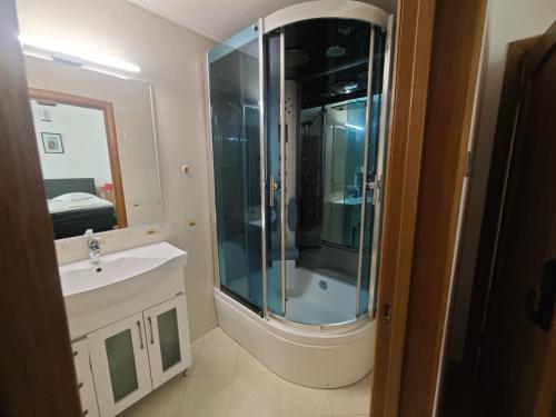 a bathroom with a shower and a sink at Ralf Residence in Bucharest
