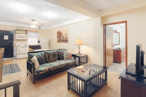 a living room with a couch and a table at Family Getaway Suite at Hummingbird Home Suites Gold Standard Certified in San Pedro