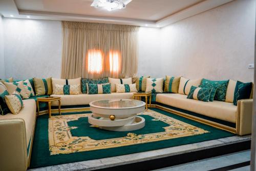 a living room with couches and a coffee table at dakhla home in Aït Krad