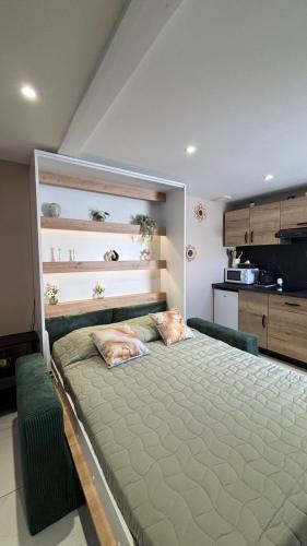 a bedroom with a bed with two pillows on it at La Parenthèse in Sangatte