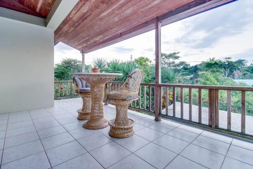 a patio with a table and chairs on a balcony at Suite at Villa Maya -Gold Standard and Certified in San Ignacio