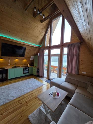 a living room with a couch and a table at Cabana BBO - Jacuzzi, TV and Terasse in Colibiţa