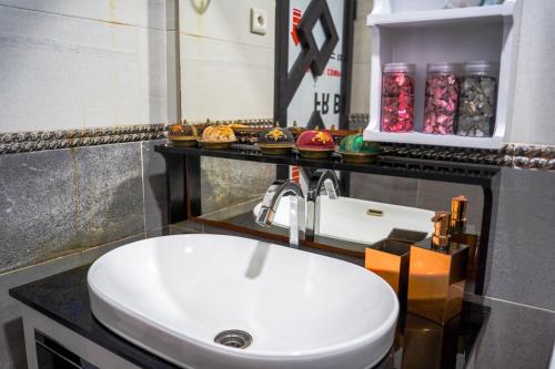 a bathroom with a white sink and a counter at dakhla home in Aït Krad