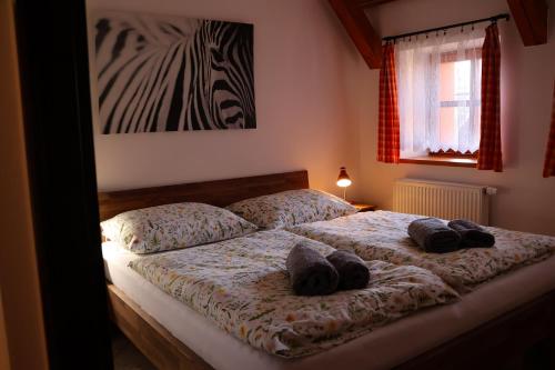 a bedroom with two beds with hats on them at Farma Wenet in Broumov