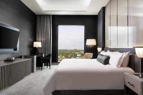 a hotel room with a large bed and a large window at Loews Arlington Hotel in Arlington