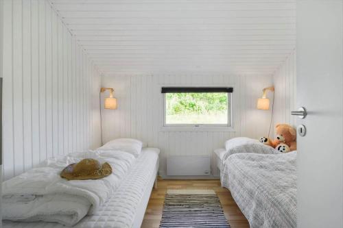 a bedroom with two beds and a window at JB507-Fjerritslev-Perikumvej-50 in Slettestrand