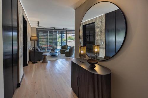 a living room with a large mirror on the wall at At Home Alonso in Santiago