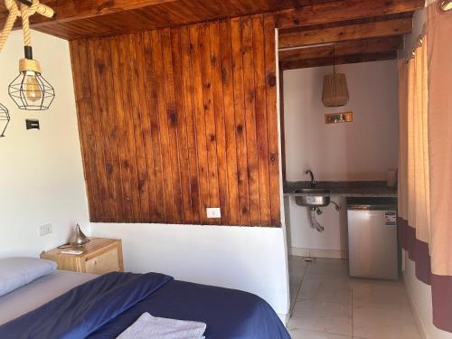 a bedroom with a bed and a kitchen with a sink at Leonessa's Villa in Dahab
