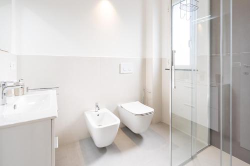 a bathroom with a toilet and a sink and a shower at GiuMar Apartments Acitrezza in Aci Catena