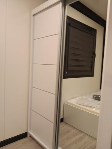 a bathroom with a closet with a mirror at Domki u Krukow in Łuka