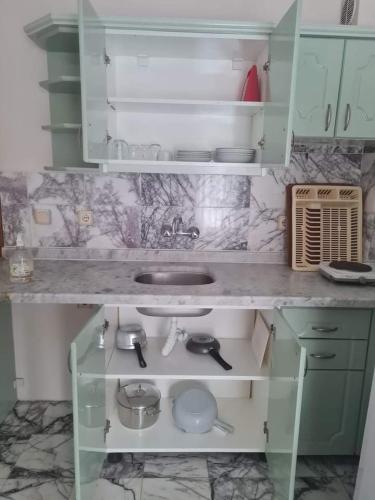 a kitchen with a sink and a counter top at ÖZ-AY APART OTEL in Marmaris