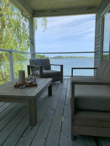 a screened in porch with a couch and a coffee table at On Da Water in Lunenburg