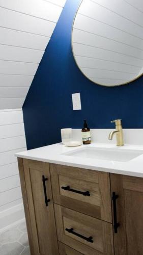 a bathroom with a sink and a mirror at Queen Suite with Private Ensuite at Fancie's PEC - Suite 1 in Belleville