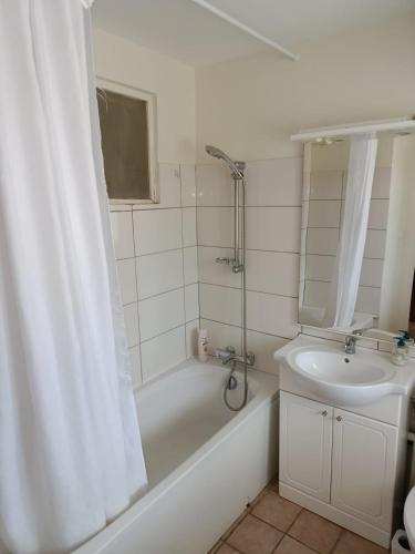 a bathroom with a tub and a sink and a shower at Maison Charton in Château-Chinon
